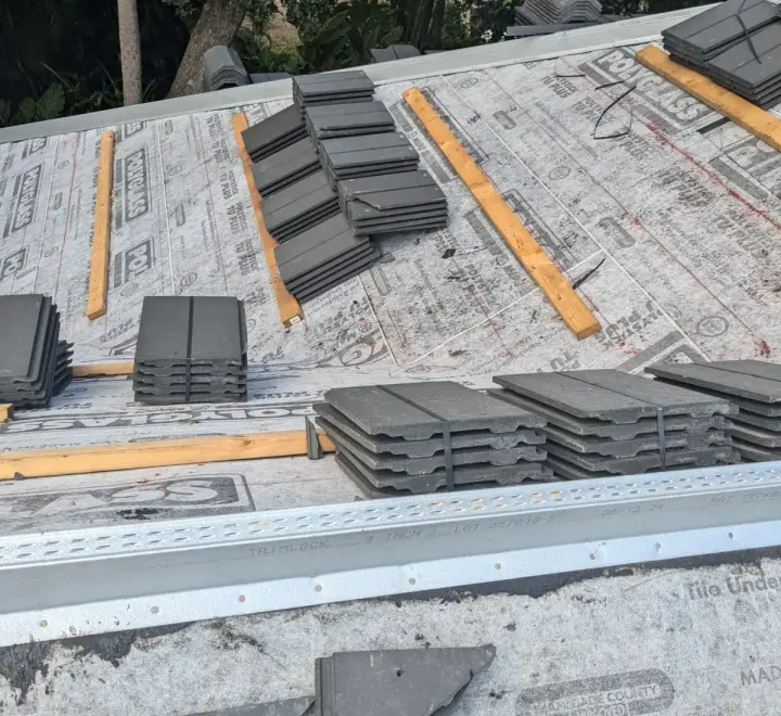 Charcoal flat tile roof installation by DR Construction & Roofing in South Florida